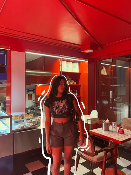 A simple white outline doodle makes me stand out in this very red cafe.