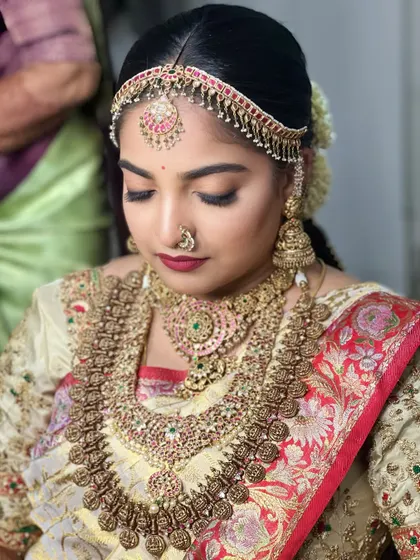 A close-up on the eye makeup shows a soft blend of neutral tones with a sharp wing. This is a versatile technique you'll master, suitable for many different bridal looks.