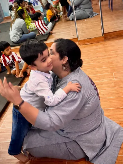 It's all about the connection. A warm hug between an instructor and a happy child captures the safe, nurturing, and family-like environment we cultivate in all our workshops and classes.