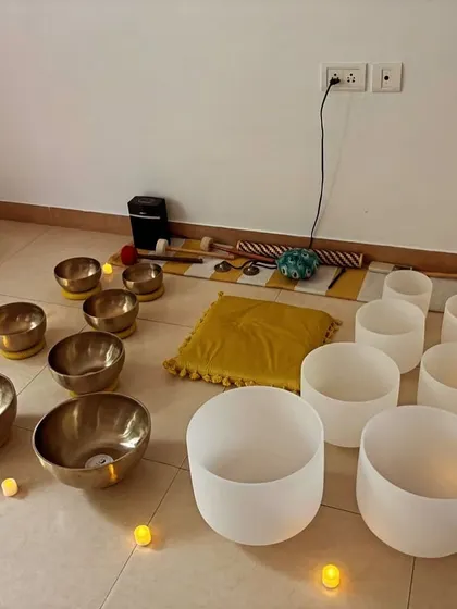 Another view of a graduate's studio setup, with Tibetan and crystal bowls illuminated by candlelight. This serene ambiance is perfect for creating a deeply immersive and healing sound bath experience.