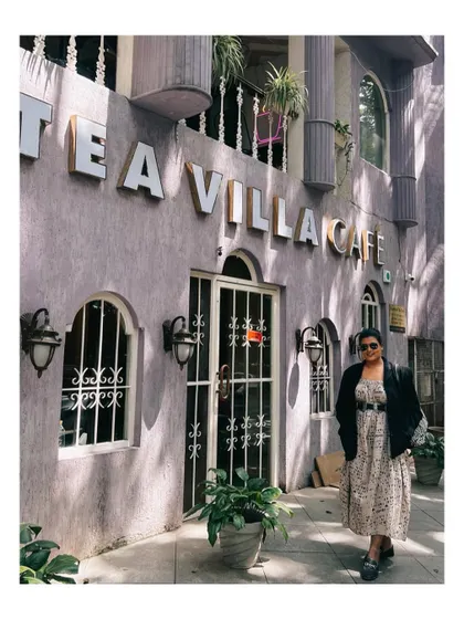 Standing outside a cafe in my layered work-to-weekend outfit. I help clients build wardrobes with pieces that can be styled for both professional settings and casual outings.
