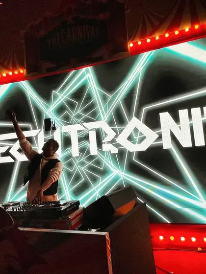 A great shot in front of my custom visuals. Branding and stage presence are a huge part of the professional package I bring to every gig.