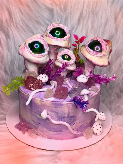 I love creepy and bizarre requests. This cake features surreal, eye-watching mushrooms on a purple marbled base, decorated with edible crystals. It's wonderfully weird.