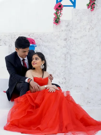 A sweet and romantic pre-wedding photo. The couple shares a quiet moment together on the steps, lost in their own world.