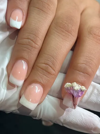 A classic French manicure with a twist. Adding a delicate bunch of 3D flowers makes the design so unique and perfect for a special occasion.