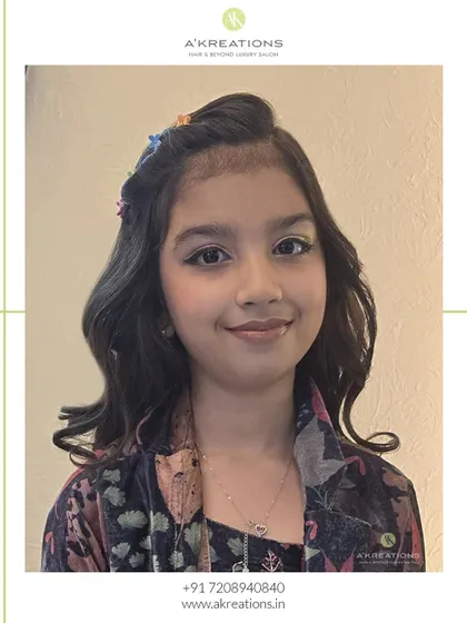 Adorable and stylish! We gave this young client soft waves, a cute braided headband with floral clips, and a touch of light, shimmery makeup.