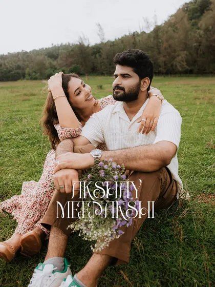 A relaxed and happy portrait of a couple sitting in a field, personalized with their names.