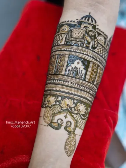 The completed armlet design, with peacocks, lotuses, and elephants creating a stunning piece of traditional mehendi art.