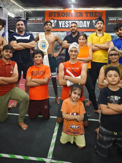 Another team photo with the championship belt, showing our winning attitude.