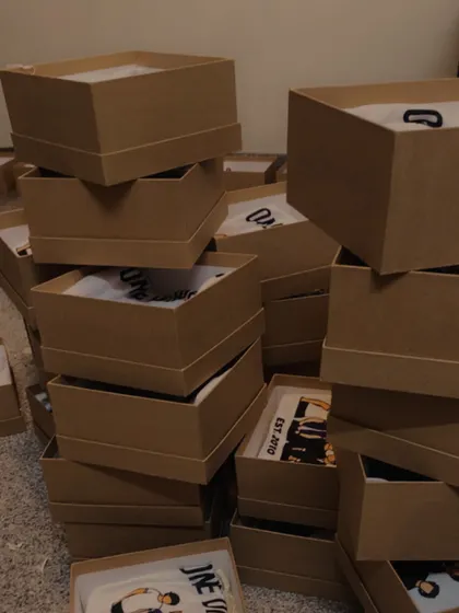 The behind-the-scenes of a bulk order for our One Direction hampers. Stacks of boxes ready to be filled and shipped to fans.