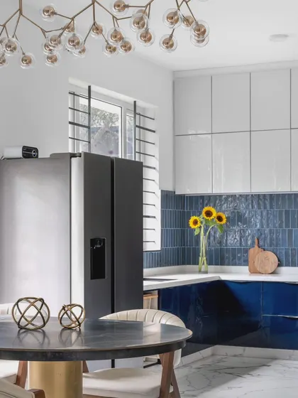 This view shows the kitchen's connection to the dining area. The open layout is perfect for modern living, allowing for easy interaction between spaces while maintaining a cohesive design language.
