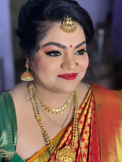 For her daughter's naming ceremony, this client wanted glittery eyes, and I was happy to deliver. I created a warm, glittery eye look with a classic red lip, which looked beautiful with her traditional silk saree and gold jewellery.