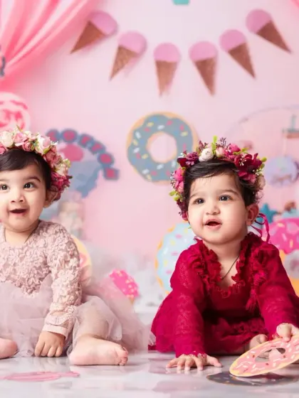 Two happy faces in a land of sweets. This twin photoshoot captures the joy of turning one.