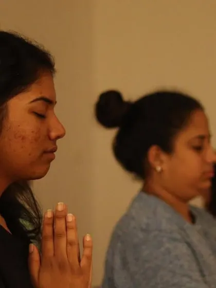 In sound we are born, in sound we are healed. A moment of quiet reflection during a sound healing session, where students absorb the therapeutic vibrations of the singing bowls.