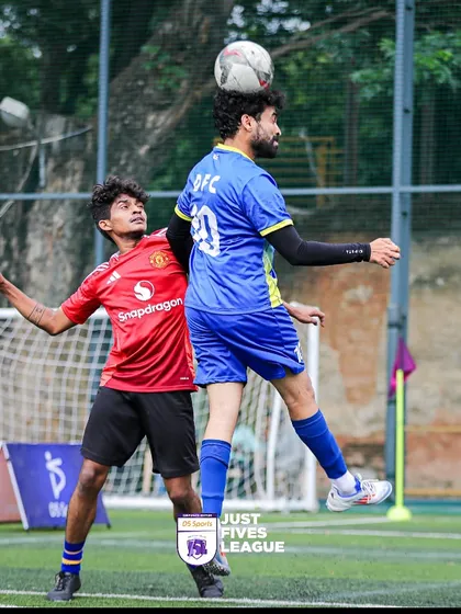 An aerial battle for the ball shows the skill and athleticism on display at our corporate football tournaments. Players give their all, making for an exciting spectator experience.