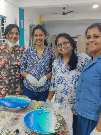 The smiles on their faces say it all! A group of ladies posing with their beautiful, freshly poured resin ocean art.