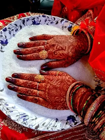 This is the moment every bride waits for. The deep, rich burgundy stain of my homemade organic henna, beautifully complementing the traditional bridal attire.
