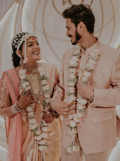 A happy, candid moment between the newly engaged couple. Their matching floral varmalas connect them and symbolize their union.