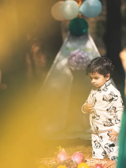 A candid shot of a little boy at his outdoor party. I often shoot through foreground elements to create a dreamy, intimate feel that draws you into the moment.