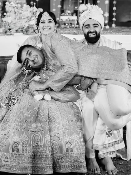 A hilarious, unposed moment with a friend crashing the couple's portrait. These are the funny, unexpected memories that make a wedding unique.