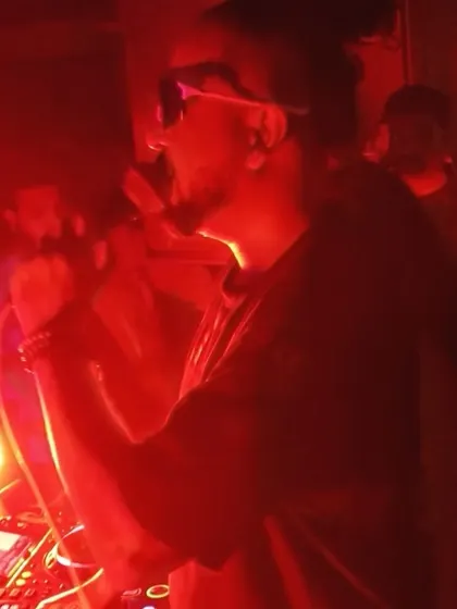 On the mic during a red-lit set at The Fixx.