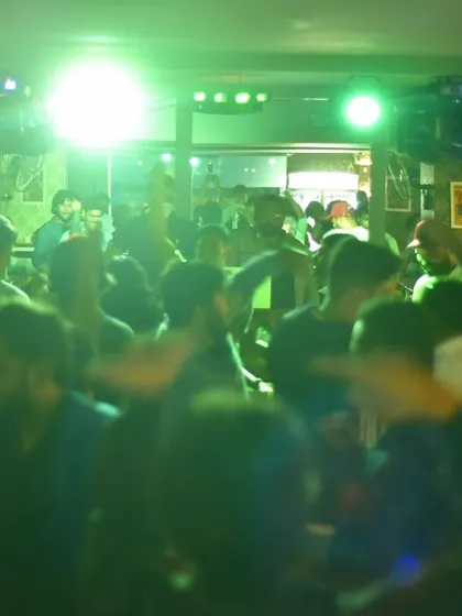 A green-lit, high-energy crowd shot from a ladies' night event in Bangalore. The motion blur shows just how much everyone was dancing.
