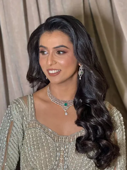 A sophisticated reception look with soft brown smokey eyes, a nude lip, and elegant Hollywood waves.