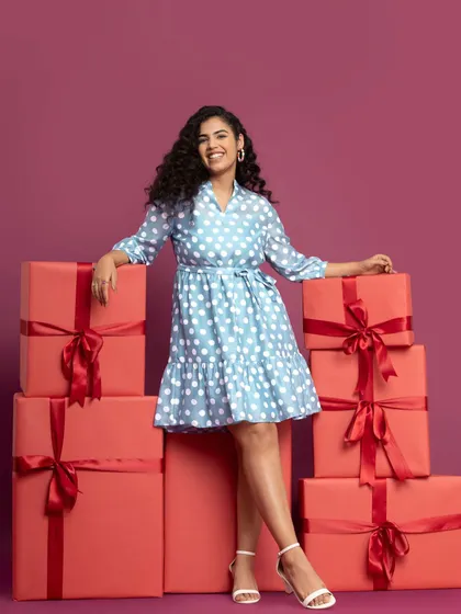 Surrounded by presents in a cute polka dot dress. This was such a fun shoot to be a part of.