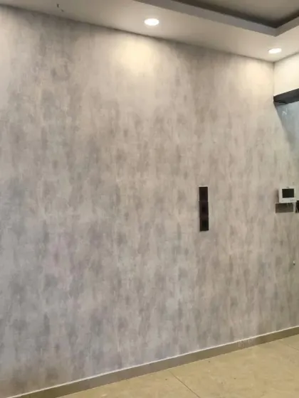 A grey wallpaper with a subtle concrete or stone texture. This is great for a minimalist or industrial interior design.