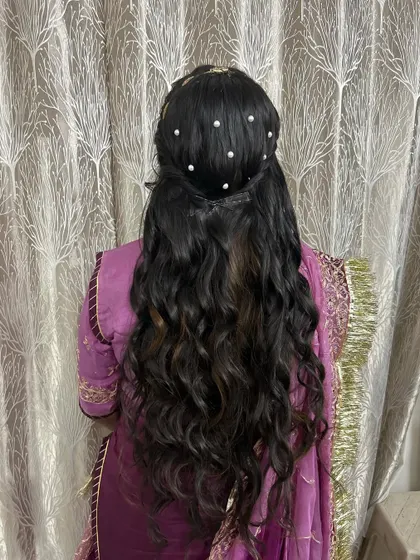 The back of the hairstyle for the Marwadi Haldi ceremony. I created soft waves and decorated them with pearl accessories.