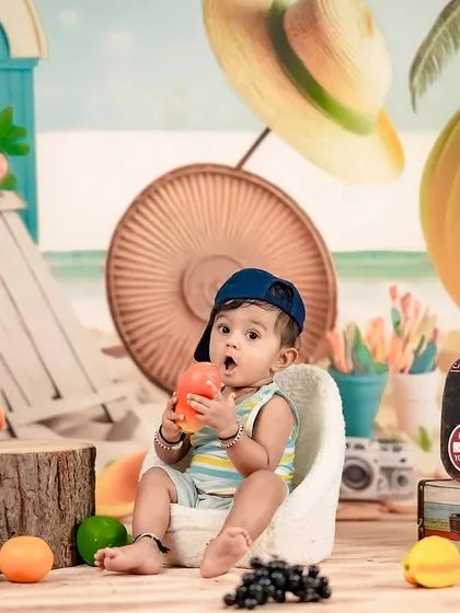 A day at the beach! This little one is enjoying some snacks in our colorful and fun beach-themed studio setup.
