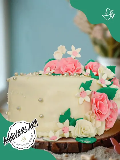 A cascade of pink and white sugar flowers adorns this beautiful anniversary cake for Mr. and Mrs. Kumar. It’s a classic design that brings a touch of floral elegance to their special day.