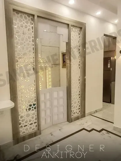 This mandir is cleverly integrated into the living room furniture, with jali doors that can be closed when not in use.