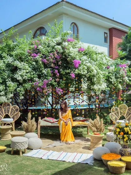 The stunning and serene decor for an intimate Haldi ceremony in Goa, set under a beautiful bougainvillea tree.