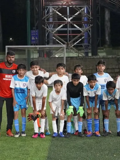 Our U11 team stands with their coaches, ready and motivated for their next match.