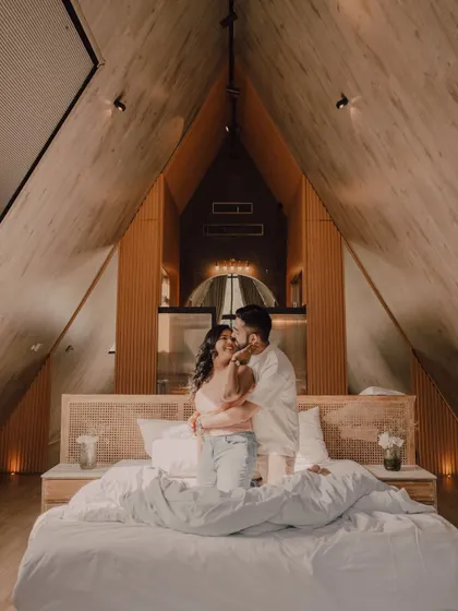 A cozy and intimate moment inside a beautiful A-frame cabin. This shows that a pre-wedding shoot can also be about capturing quiet, home-like moments together.