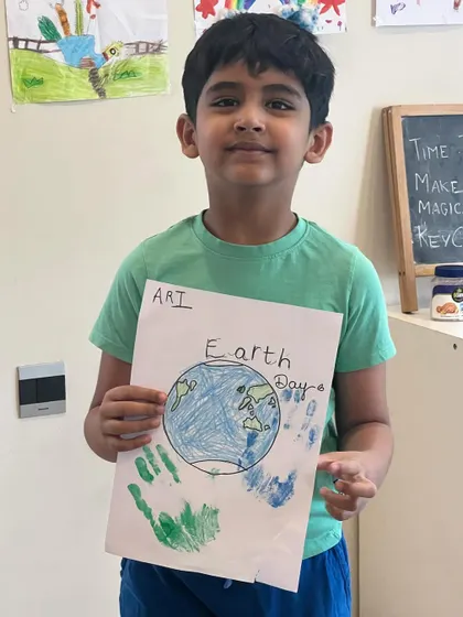This young man is happy with his Earth Day drawing, showing his vision of our planet.