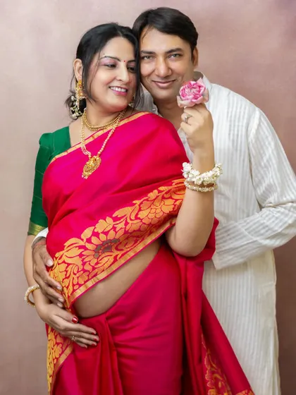 Celebrating your journey can also mean embracing tradition. This couple wanted to capture their joy in classic attire, and the vibrant color of her saree beautifully highlighted her pregnancy glow during this special maternity portrait session.