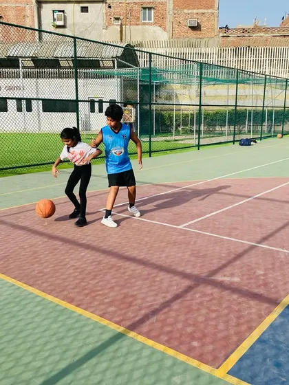One-on-one dribbling practice with our younger players, making learning fun and interactive.