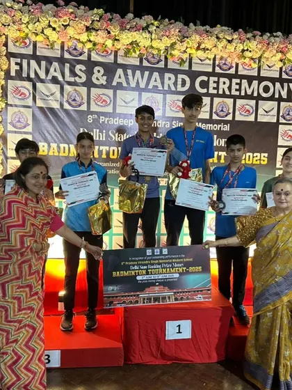 The boys' team on the podium at the Delhi State tournament award ceremony. Their medals in singles and doubles reflect their all-around skill.