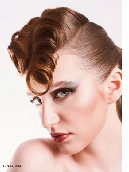 A profile view that showcases the sculptural quality of the hairstyle. The lighting is placed to create a strong highlight along the cheekbone and jawline, defining the model's features.