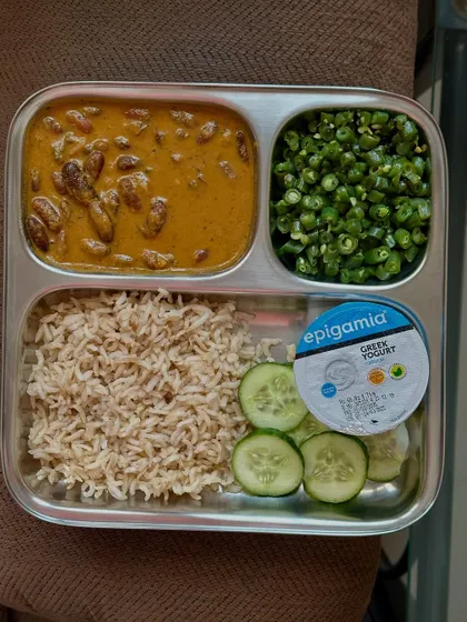 This meal features brown rice with a rich rajma curry, sautéed green beans, and fresh cucumber, with Greek yogurt to complete the balance.