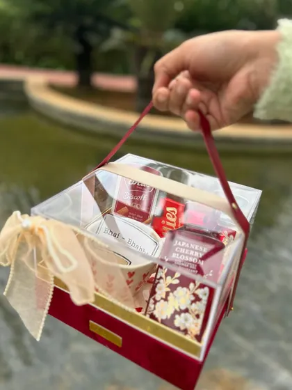 A "Chai-Rish" themed Rakhi hamper for the tea-loving sibling. The rich red velvet box and curated items make it a warm and thoughtful gift.