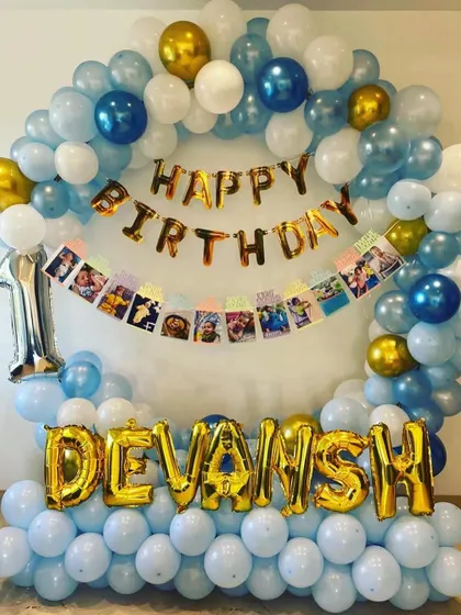 This version of the decoration includes a photo banner with pictures from the baby's first year, adding a personal touch.