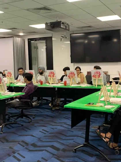 The LinkedIn office setup for our sip and paint workshop. We transform regular meeting rooms into vibrant art studios, complete with easels, canvases, and all the supplies.