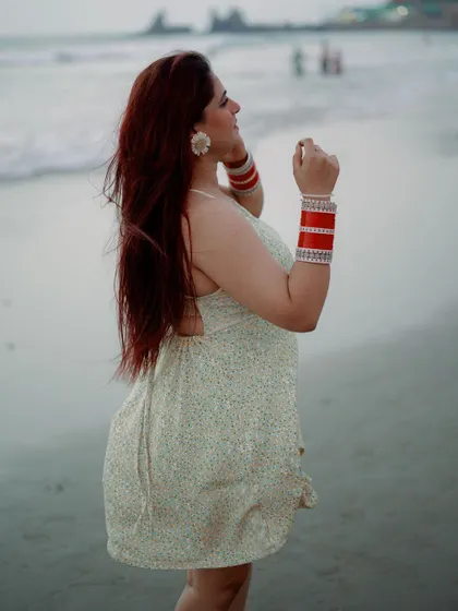 A beautiful solo portrait of the bride on the beach. The wind in her hair and the soft ocean backdrop create a feeling of freedom and happiness.