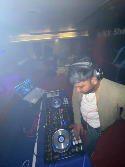 Focused on the mix in a smoky club environment. My job is to seamlessly blend tracks, building up the energy and keeping the dance floor engaged from one song to the next.