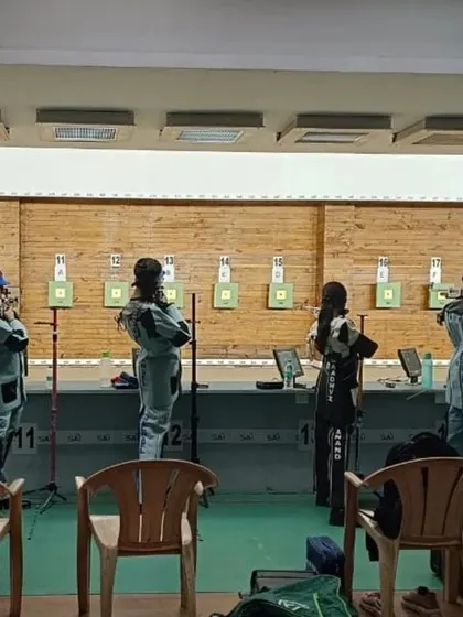 A line of our female athletes waiting for their turn to shoot during the state championship, showing focus and team camaraderie.