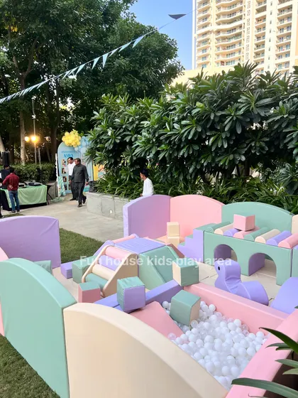 Another angle of our pastel setup, highlighting the ball pit filled with white balls and the various soft climbers and blocks for creative play.