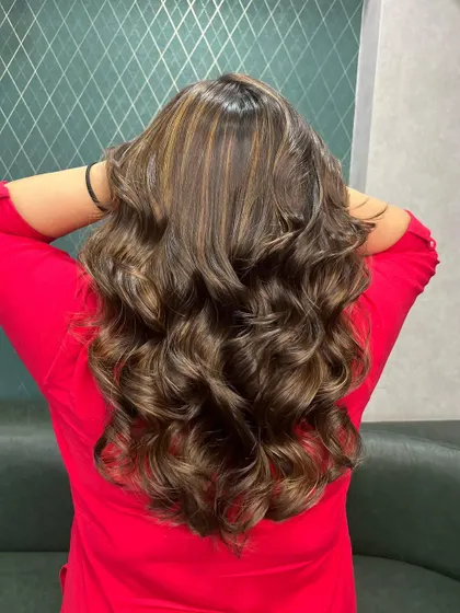 Gold locks for the new season. These beautiful highlights add a touch of glamour and shine to long, wavy hair.